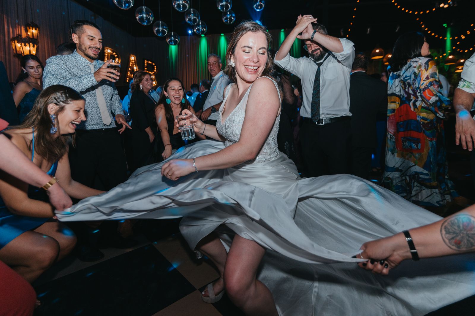 A bride dancing and celebrating with her crew on the dance floor, Brides BAEs energy