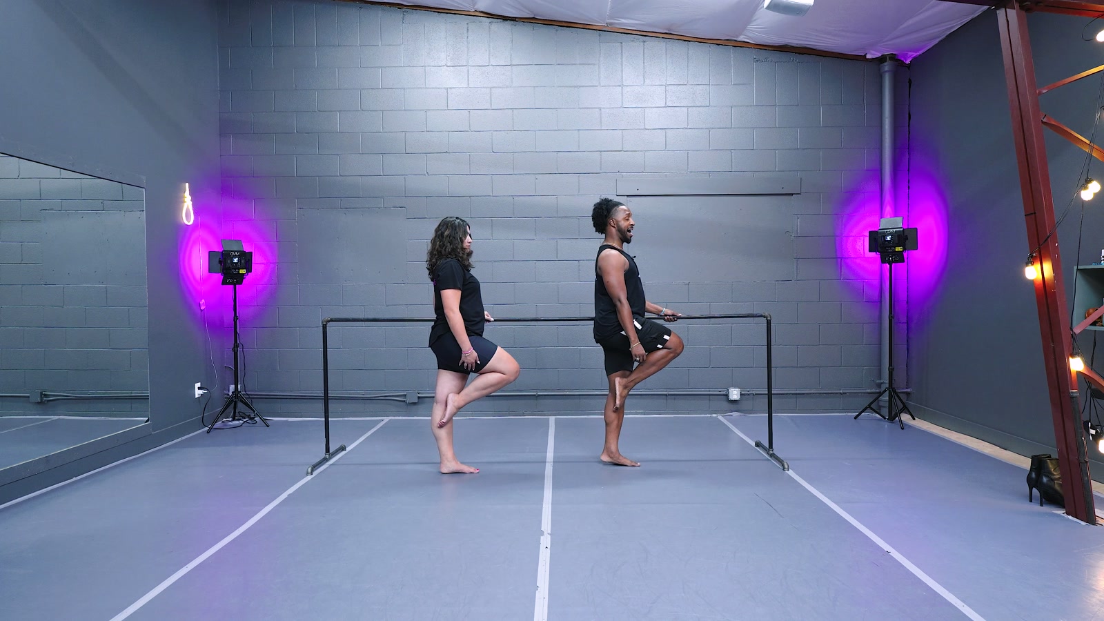 Zay teaching at the ballet barre in the studio, demonstrating the foundations